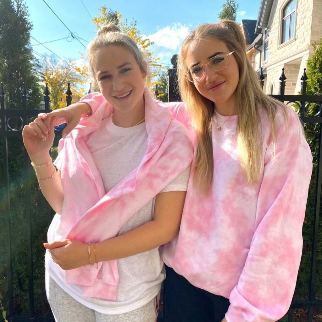 Co-founders, Daniella and Emily wearing their Cure Foundation Pink Cloud Crew Neck